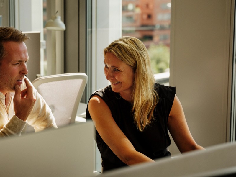 Two people talking in an office